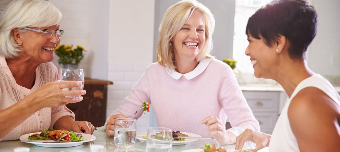 Group Of Mature Female Friends Enjoying Meal At Home